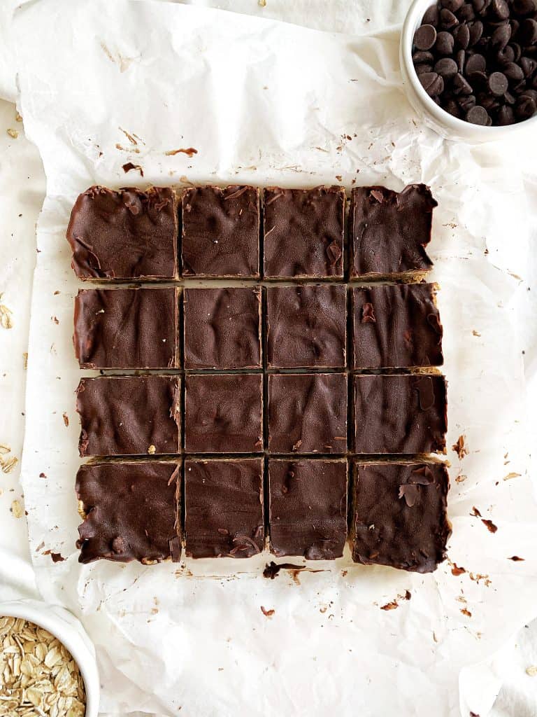 Healthy no-bake peanut butter oatmeal protein bars are packed with fiber, protein, and healthy fats to keep you full and satisfied. Using less than ten clean ingredients, the pickiest of eaters won't even realize these protein bars are healthy! Indulge your sweet tooth while nourishing your body at the same time. #proteinbars #nobake #healthyrecipes Healthy No Bake Peanut Butter Oatmeal Protein Bars