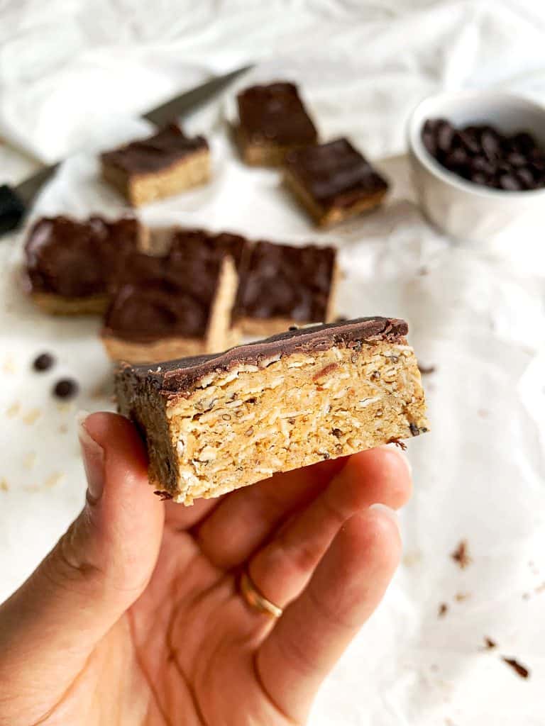 Healthy no-bake peanut butter oatmeal protein bars are packed with fiber, protein, and healthy fats to keep you full and satisfied. Using less than ten clean ingredients, the pickiest of eaters won't even realize these protein bars are healthy! Indulge your sweet tooth while nourishing your body at the same time. #proteinbars #nobake #healthyrecipes Healthy No Bake Peanut Butter Oatmeal Protein Bars