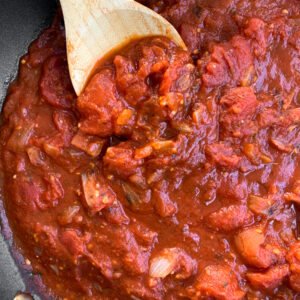 marinara sauce with wooden spoon in the pot