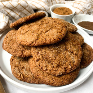close up of gluten free gingerbread cookie on a white plate