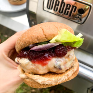 cranberry turkey burger after grilling it on a bun with toppings