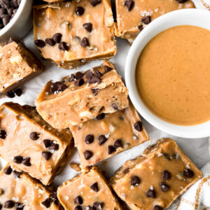 squares of peanut butter freezer fudge next to ramekin of peanut butter