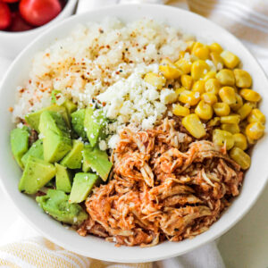 chicken tinga bowl with corn, avocado, and cauliflower rice