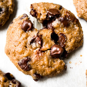 close up of chocolate chip steel cut oatmeal cookie on parchment paper