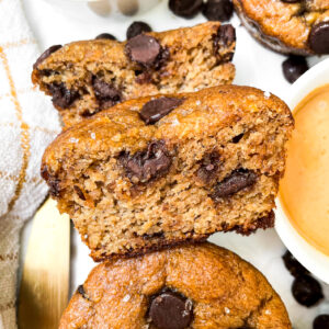 peanut butter protein muffins next to ramekin of peanut butter