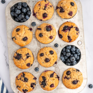 top view of banana blueberry oatmeal muffins cooling in a pan