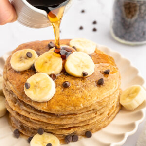 Syrup poured on a stack of Oatmeal Cottage Cheese Pancakes.