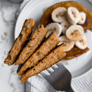 A bite of cottage cheese pumpkin pancakes on a fork.